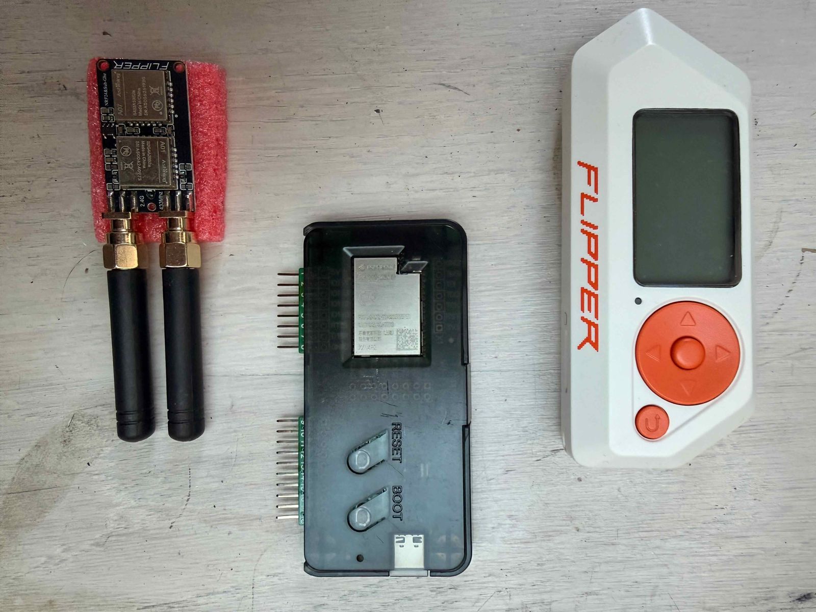 Flipper Zero naast een ESP32-bord en een NRF24- en Sub-GHz-bord met antennes